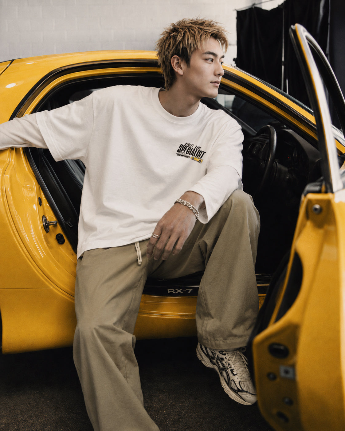 Keisuke wearing Dogfight heavyweight vintage tee sitting inside Yellow Mazda FD3S RX7