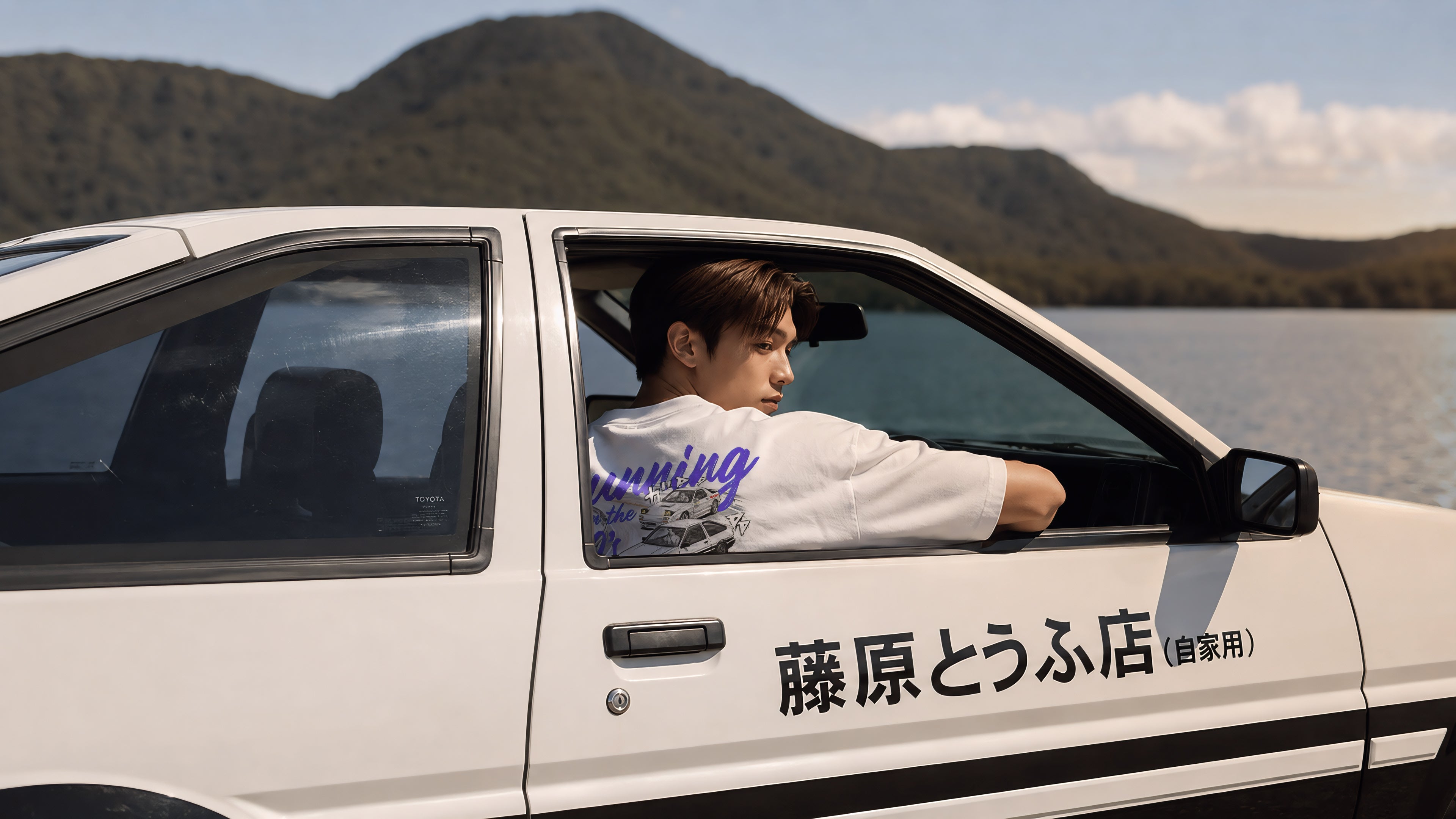 Takumi wearing the Street Race Specialist Running in the 90s heavyweight vintage tee beside a Toyota AE86